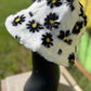 Hana brand. Floral faux fur bucket hat is white with black and yellow flowers and is 100% polyester. One size. $15