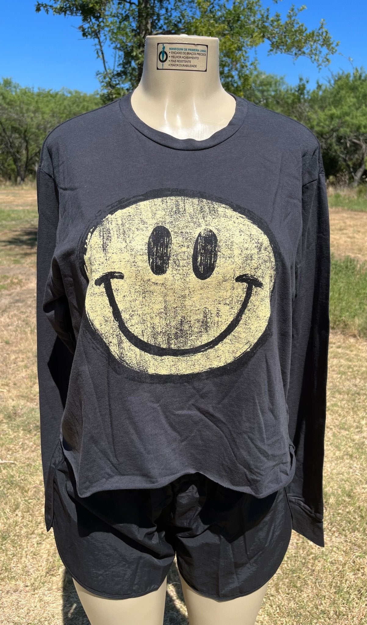 Vanilla Monkey brand. Happy face faded and distressed graphic long sleeved tee with cut hem. S, M, L $27