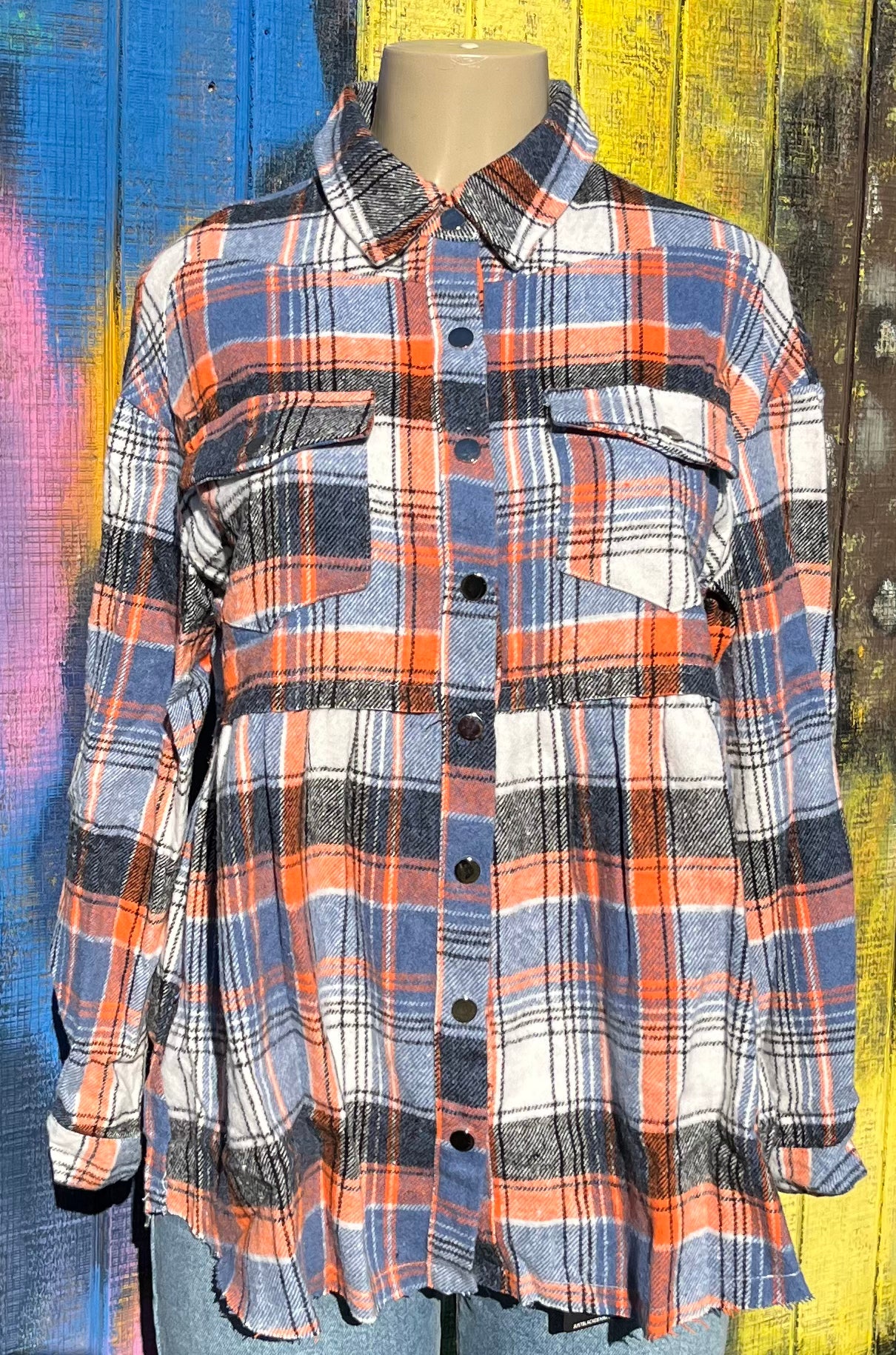 Umorger brand. Plaid flannel button down flared bottom top in blue, orange, white and black with cut hem. S, M, L, XL. $50 