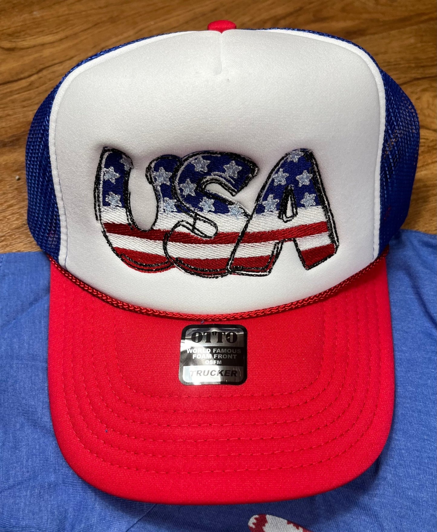 Southern Attitude Designs Inc brand. Patriotic Otto brand foam trucker hat with embroidered USA design and adjustable fit.