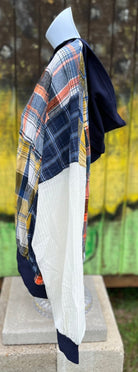 Features multicolored contrast patchwork flannel w/ waffle knit sleeves & banded navy opening w/ matching zipper & hood.