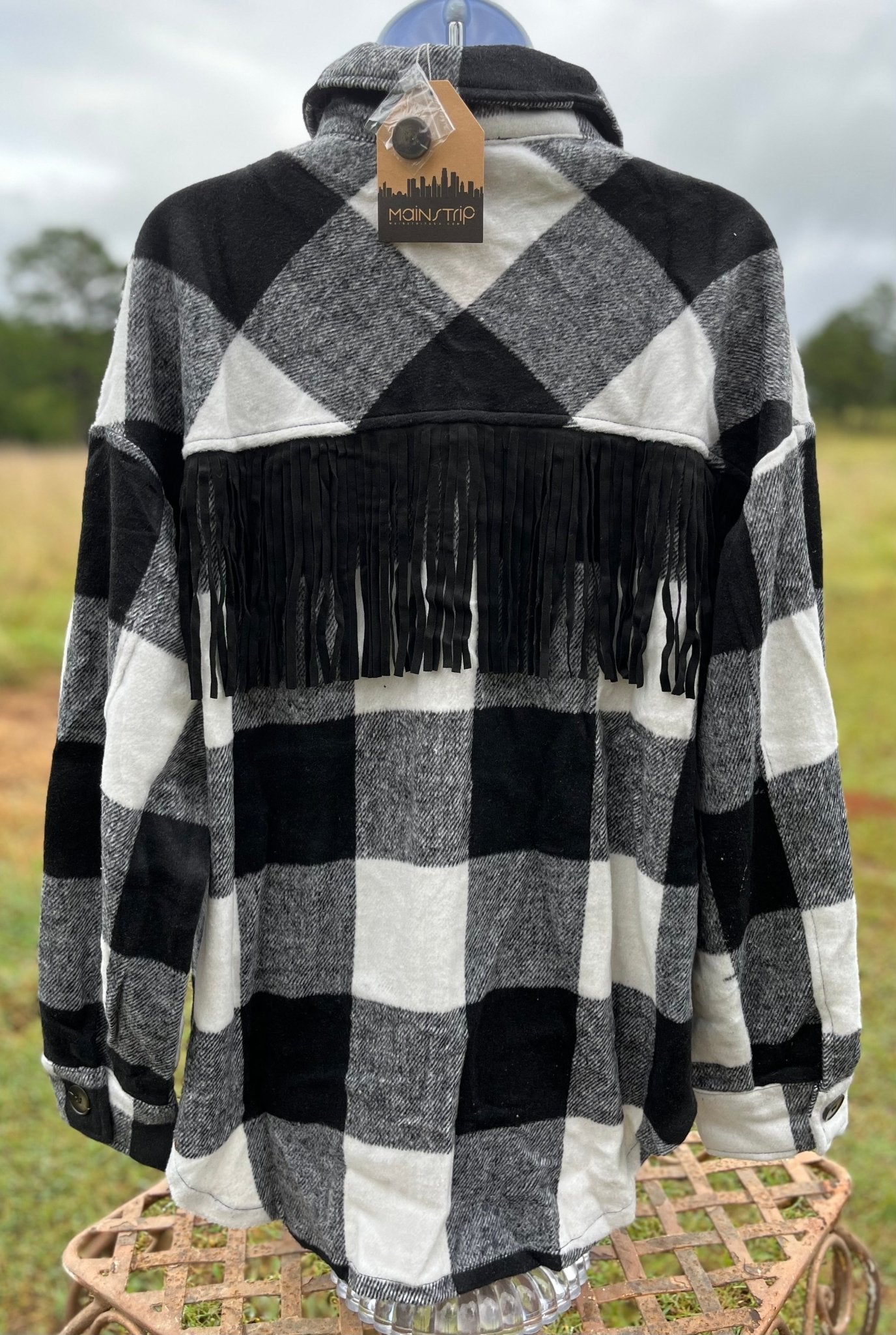 This fringe shacket is button down, buffalo plaid, with pockets & fringe detail. In red/black or white/black buffalo plaid.