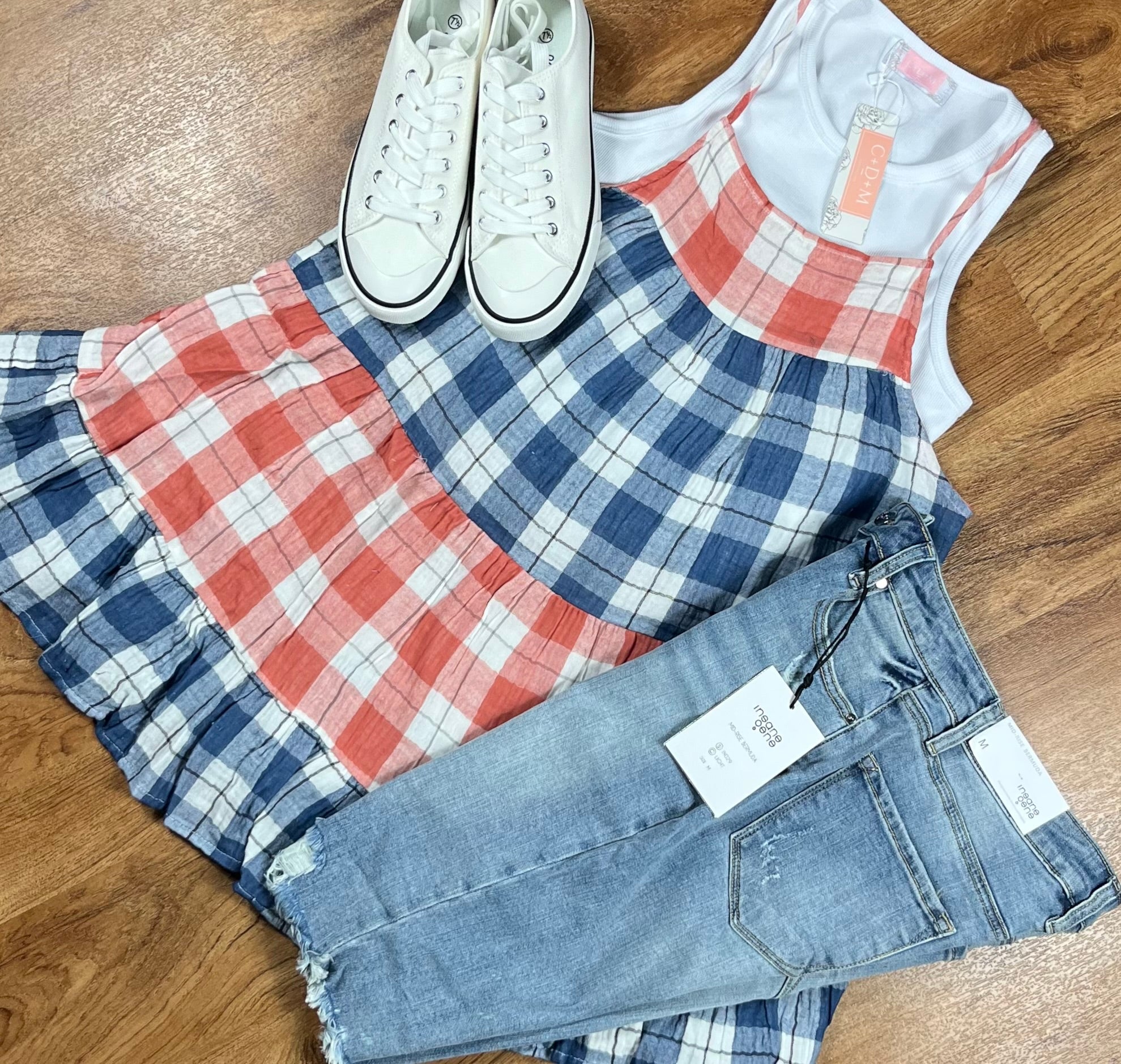 This red & blue denim checkered plaid baby doll top is tiered with a ruffled hem. Actual color may vary from images shown.