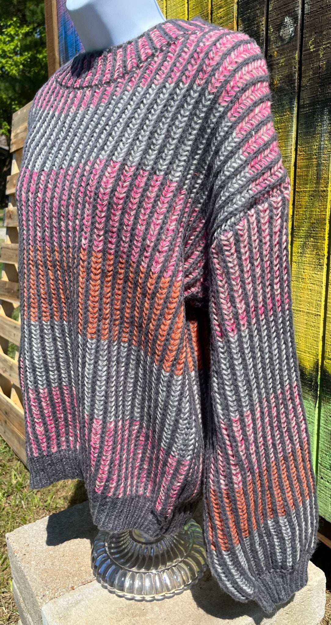 Shopin LA brand. Soft grey ribbed sweater with pink, grey and orange stripes and loose sleeves. 100% polyester. S, M, L $27