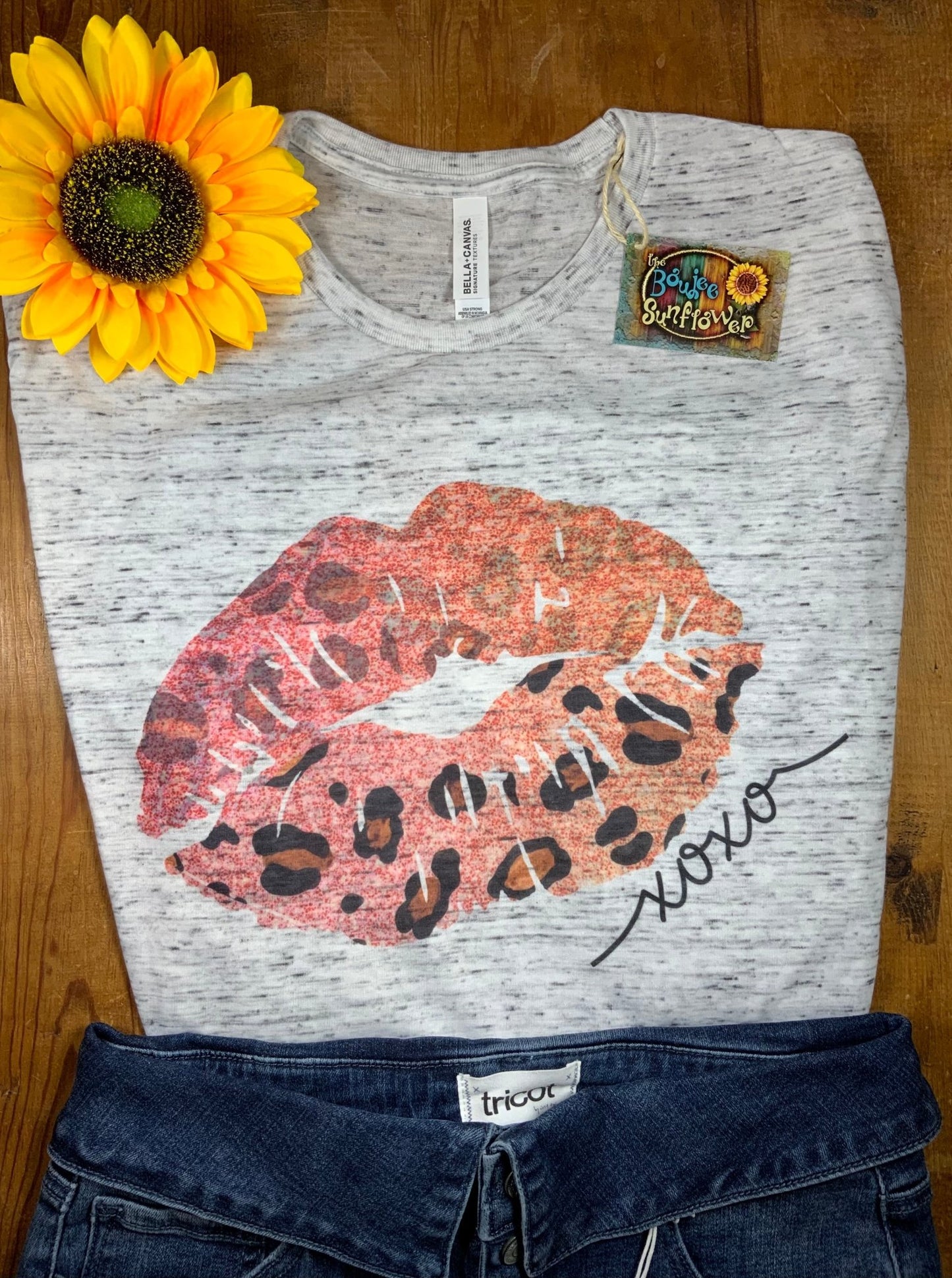 GLITTER AND GLAM brand. White marbled Bella Canvas tee with pinkish peach leopard accented lips. S, M, L $15