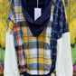 Features multicolored contrast patchwork flannel w/ waffle knit sleeves & banded navy opening w/ matching zipper & hood.