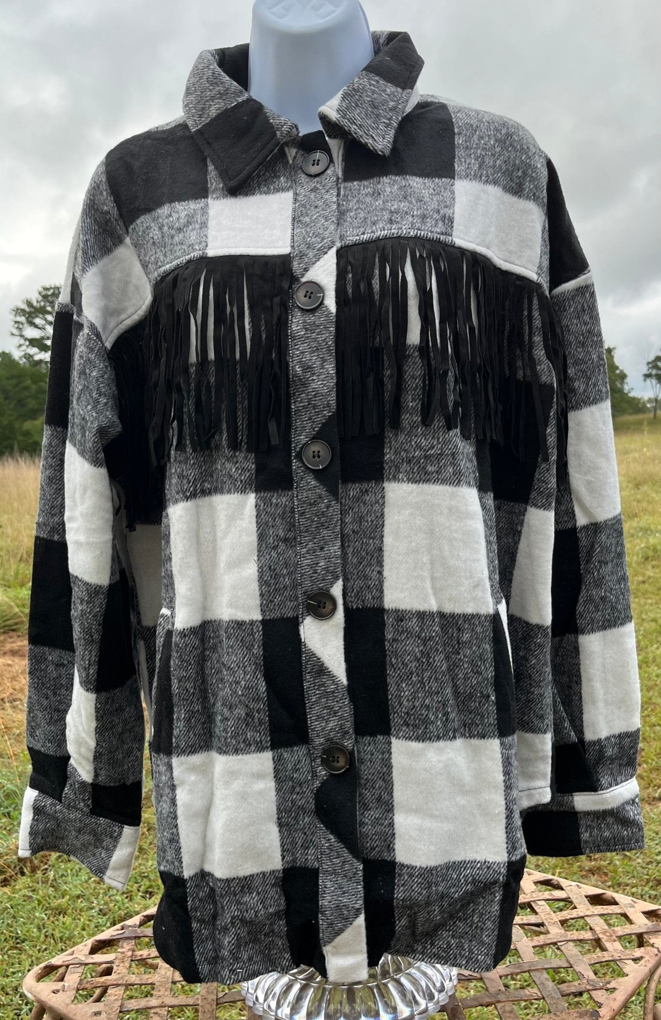 This fringe shacket is button down, buffalo plaid, with pockets & fringe detail. In red/black or white/black buffalo plaid.