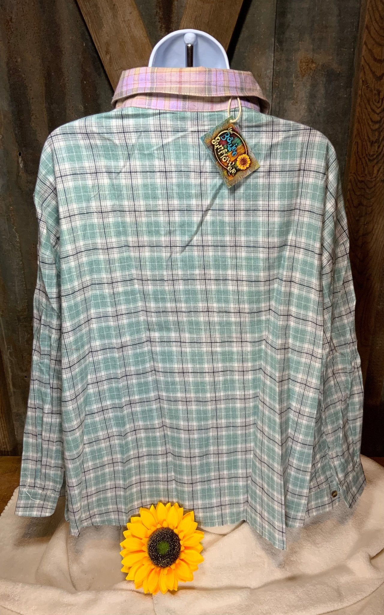 Unishe brand. Two tone plaid blouse in soft, lightweight cotton is a multicolored button down with front pocket and cut hem.