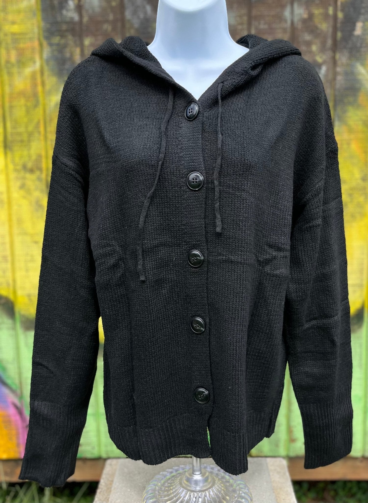 Button front hooded cardigan with adjustable drawstrings and ribbed cuffs is available in classic black, grey or off white.