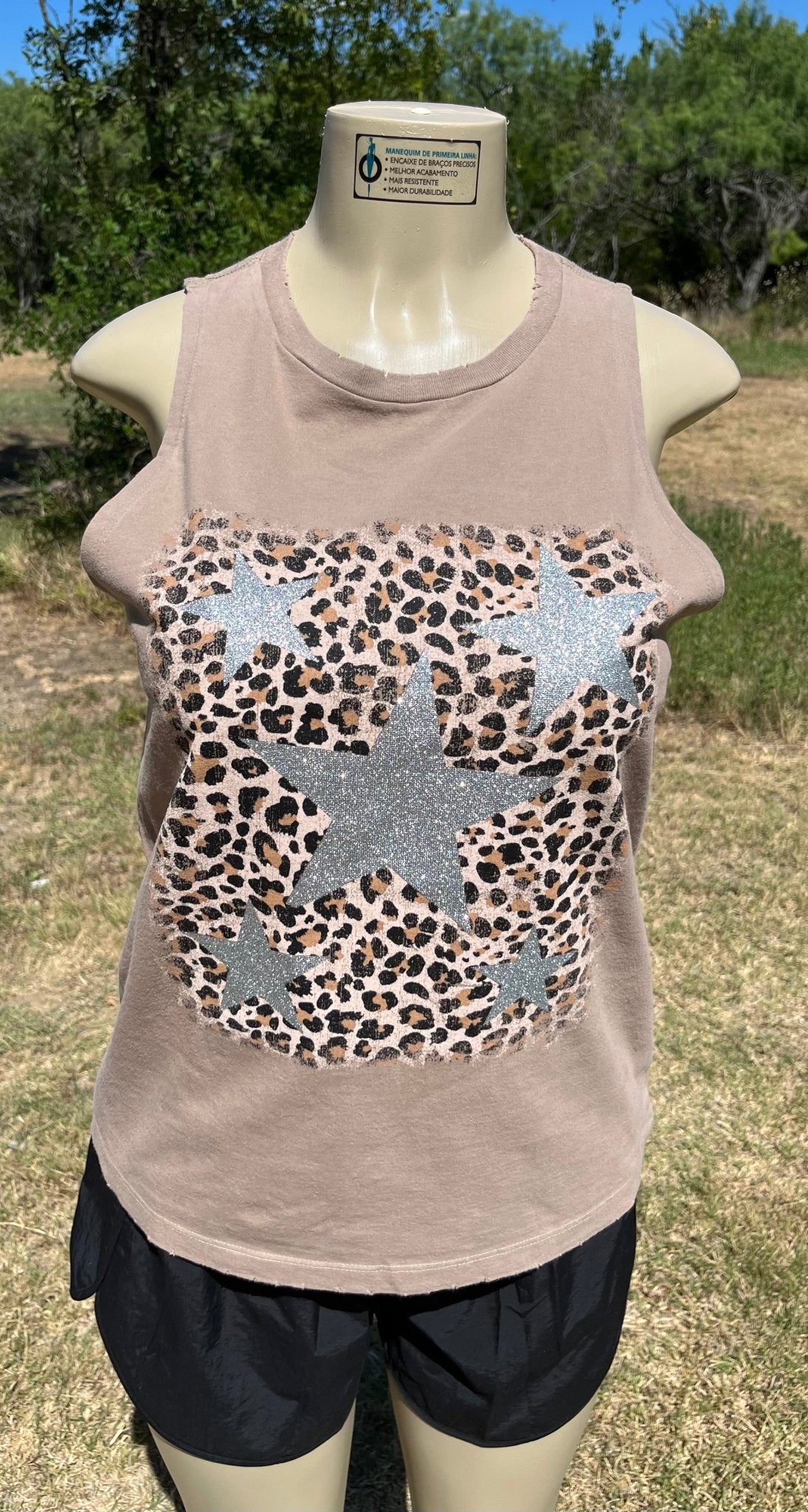 Vanilla Monkey brand. This sand colored sleeveless tee has sliver glittered stars on leopard print background. S, M, L $20