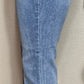 Judy Blue brand. Mid rise, release hem, cropped bootcut jean has front pocket distressed accent.