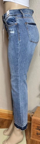 Judy Blue brand. Mid rise, release hem, cropped bootcut jean has front pocket distressed accent.