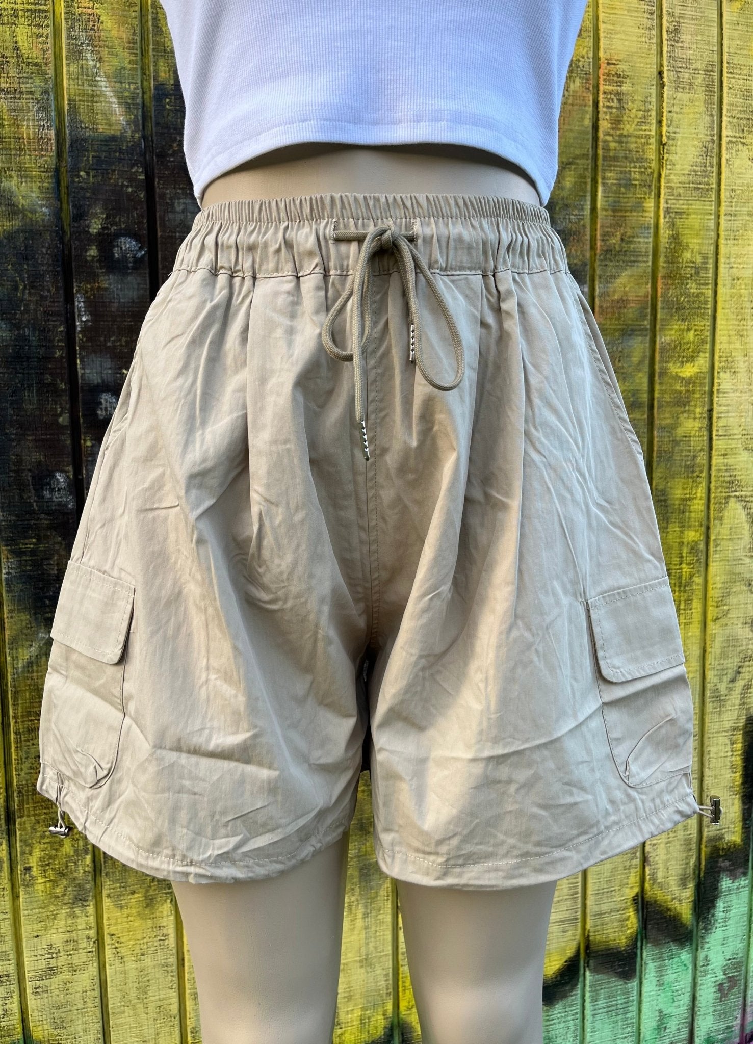 ADORA LA brand. Wide leg cargo shorts in khaki, black and gray. Lightweight with elastic drawstring waist and wide legs.