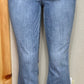 Judy Blue brand. Mid rise, release hem, cropped bootcut jean has front pocket distressed accent.