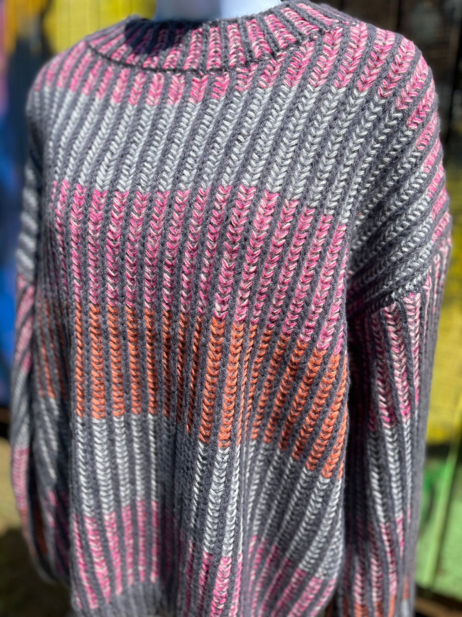 Shopin LA brand. Soft grey ribbed sweater with pink, grey and orange stripes and loose sleeves. 100% polyester. S, M, L $27