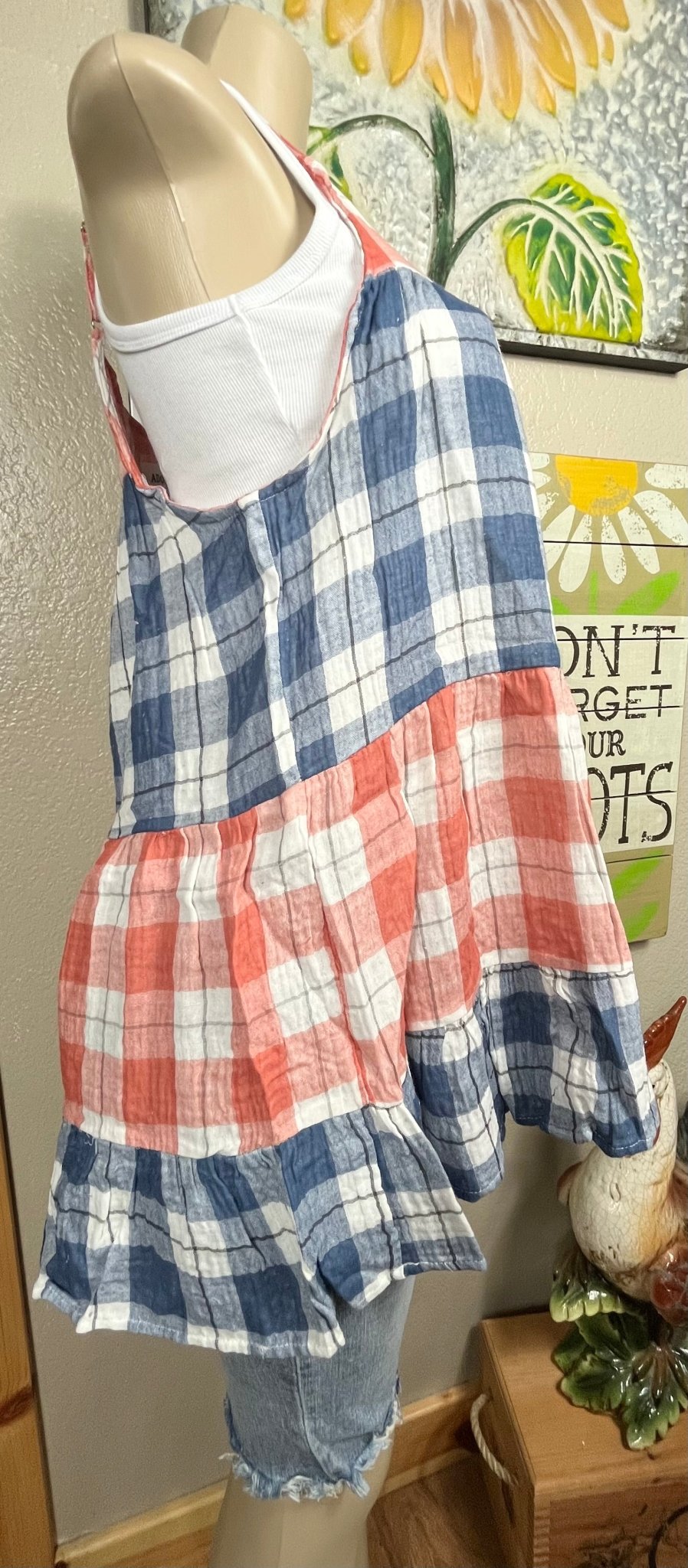 This red & blue denim checkered plaid baby doll top is tiered with a ruffled hem. Actual color may vary from images shown.