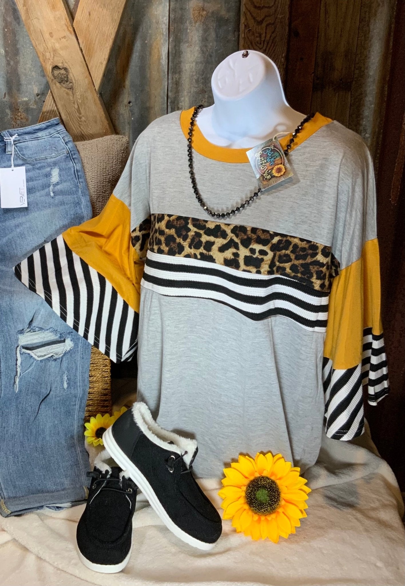 And the Why brand. This lightweight gray top with wide sleeves has mustard colored, white/black stripes,  leopard accents.