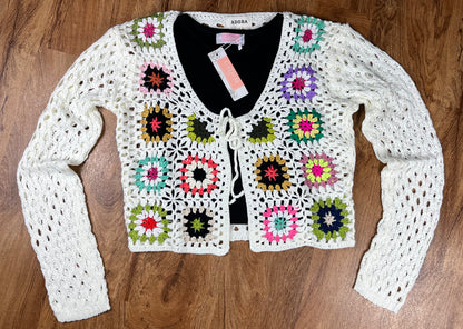 ADORA LA brand. This front tie crocheted cardigan is available in black or cream. Randomly sewn multicolored granny squares.