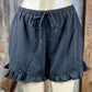 Main Strip brand. Drawstring tie waisted shorts with ruffled bottom hem. Loose fit. Available in Dusty Rose and Black.