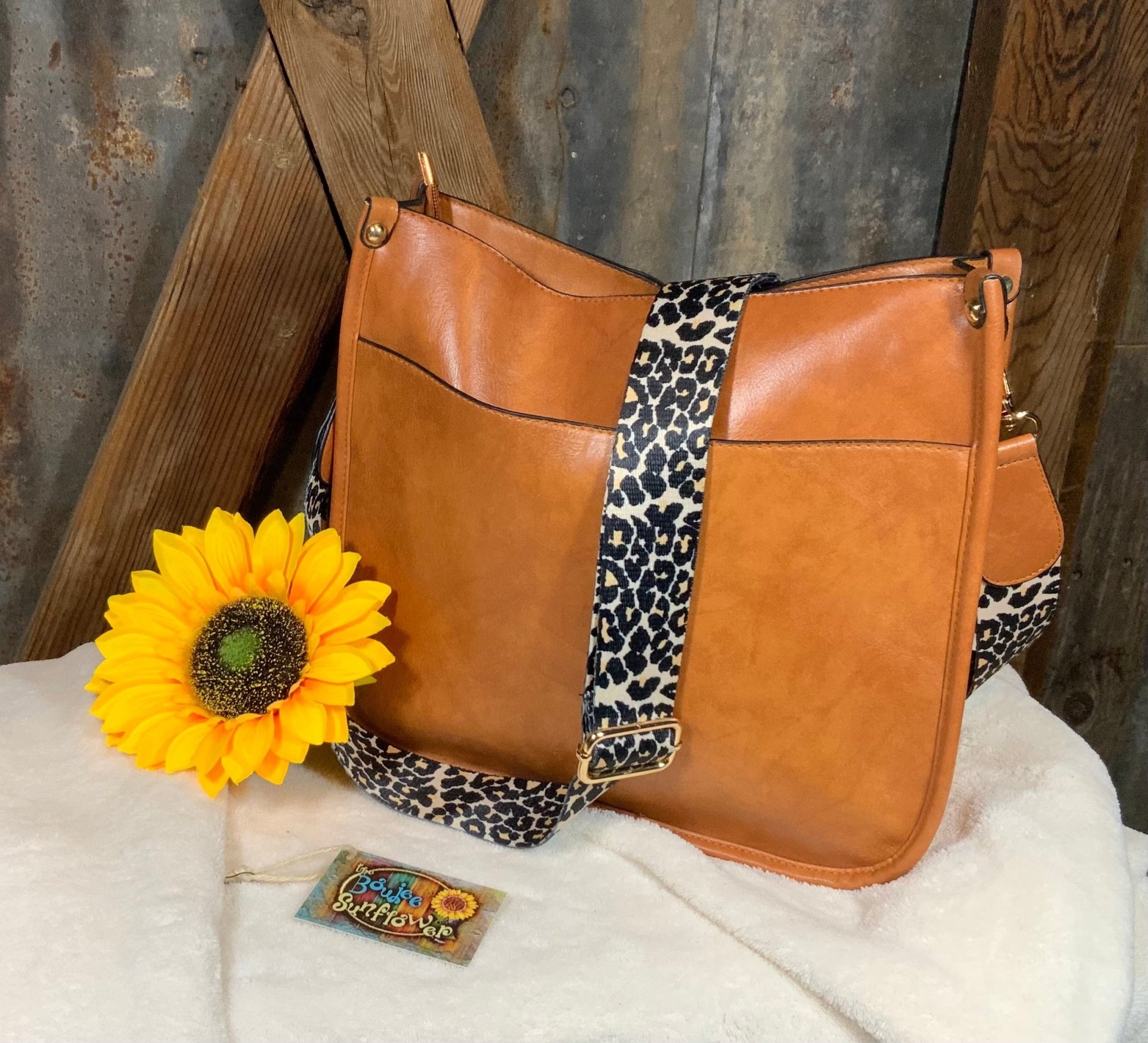 LivFoxy brand. Tan color with leopard print strap Sydney crossbody. Outer open pocket and zippered pouch. $35