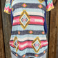 Celeste Clothing brand. Aztec and striped design print with navy accents, short sleeves with multicolored chevron pattern.