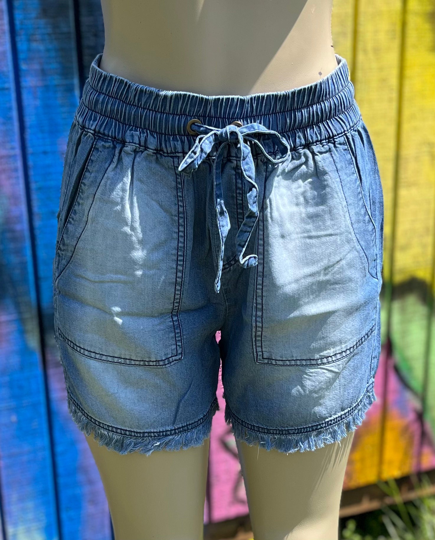 42POPS brand. These Chambray shorts feature a frayed hem, side pockets and elasticized drawstring waist. S, M, L, XL $20