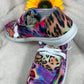 Multi-bright colored design with vibrant tiger and leopard print slip-ons. White lace detail. White lightweight soles.