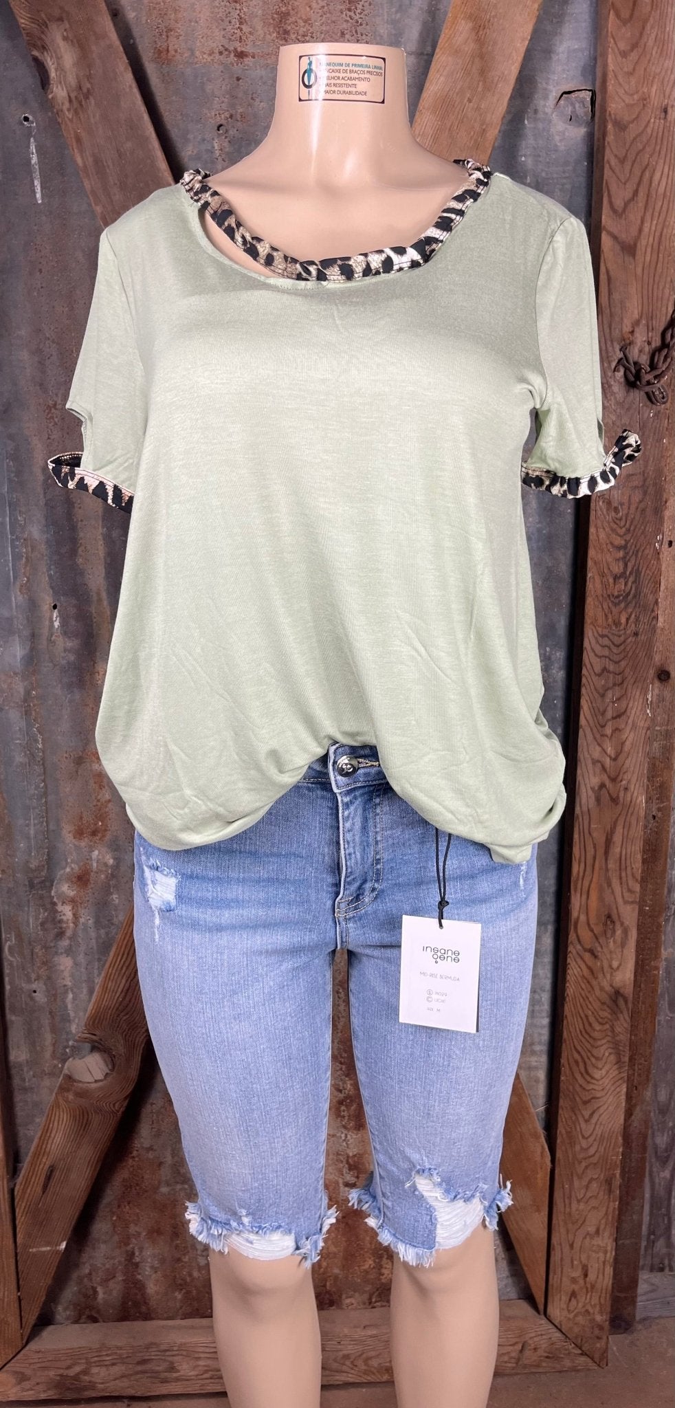 Celeste Clothing brand. Light sage green top with leopard trim cut out detail on neck and sleeves. S, M, L, XL. $15