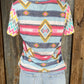 Celeste Clothing brand. Aztec and striped design print with navy accents, short sleeves with multicolored chevron pattern.