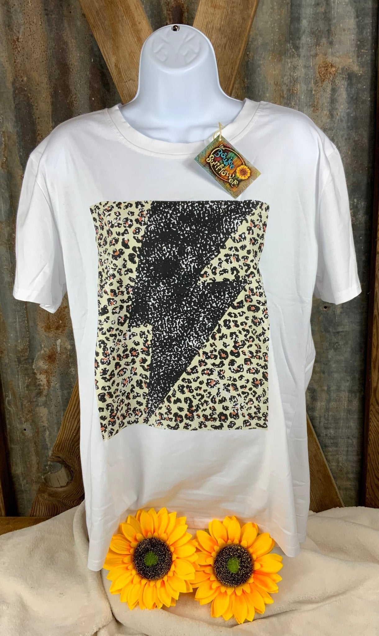 ESLEY brand. Tee available in light blue, white or peach with black lightning bolt and leopard design. S, M, L, XL. $10