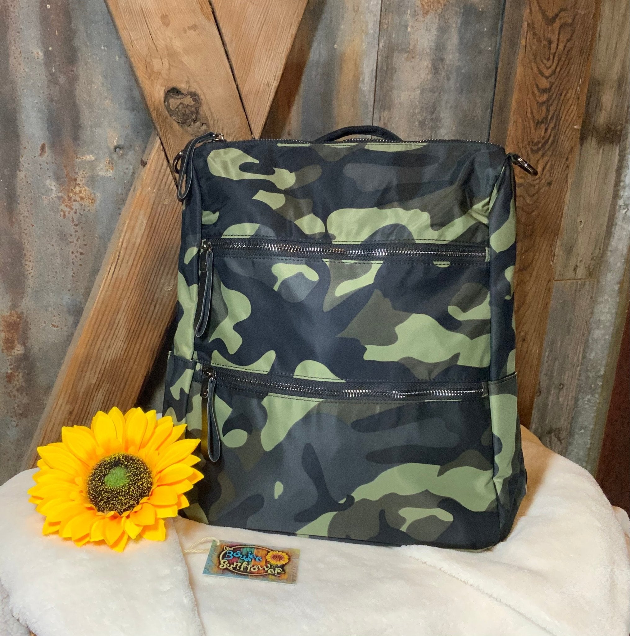 This lightweight backpack in camo or black has a roomy interior and zippered outside pouch. Bag measures 15" x 10" x 5".