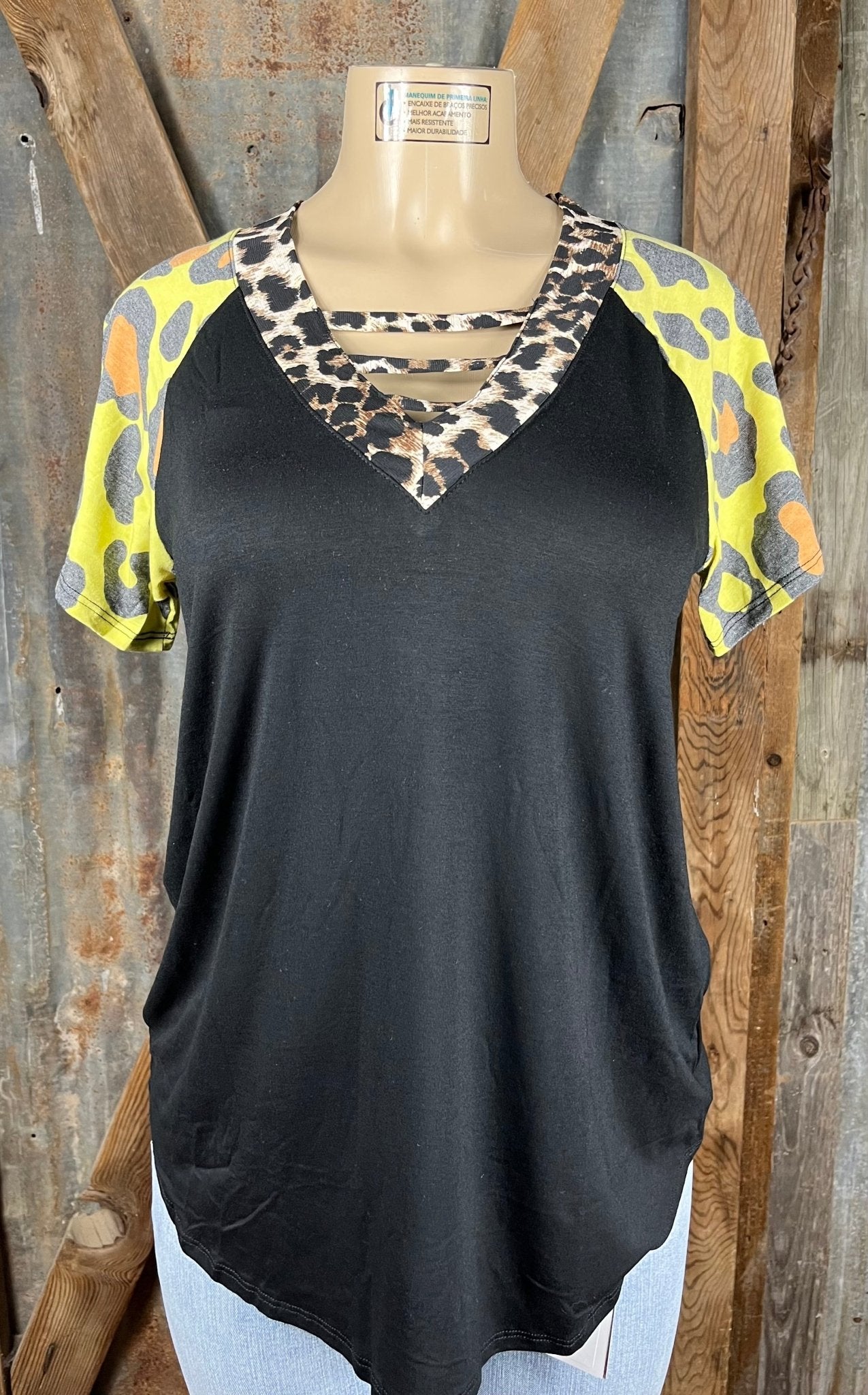 All That Sass! Women's Top Classic Leopard v-neck with black bodice and yellow short sleeves accented with orange and gray leopard.