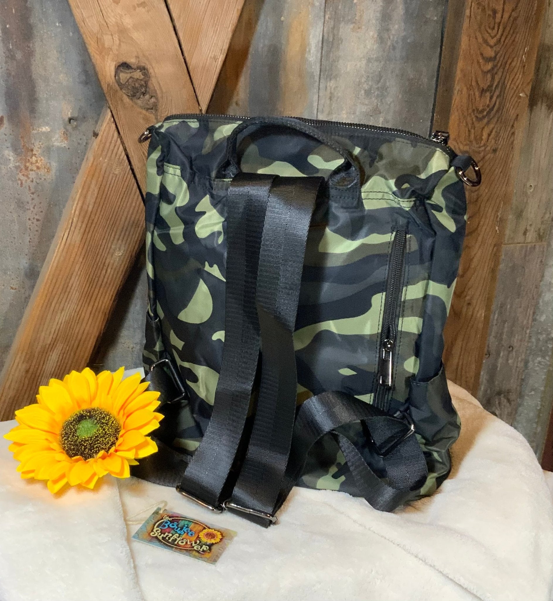 This lightweight backpack in camo or black has a roomy interior and zippered outside pouch. Bag measures 15" x 10" x 5".