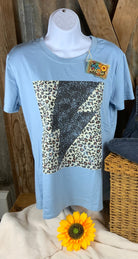 ESLEY brand. Tee available in light blue, white or peach with black lightning bolt and leopard design. S, M, L, XL. $10