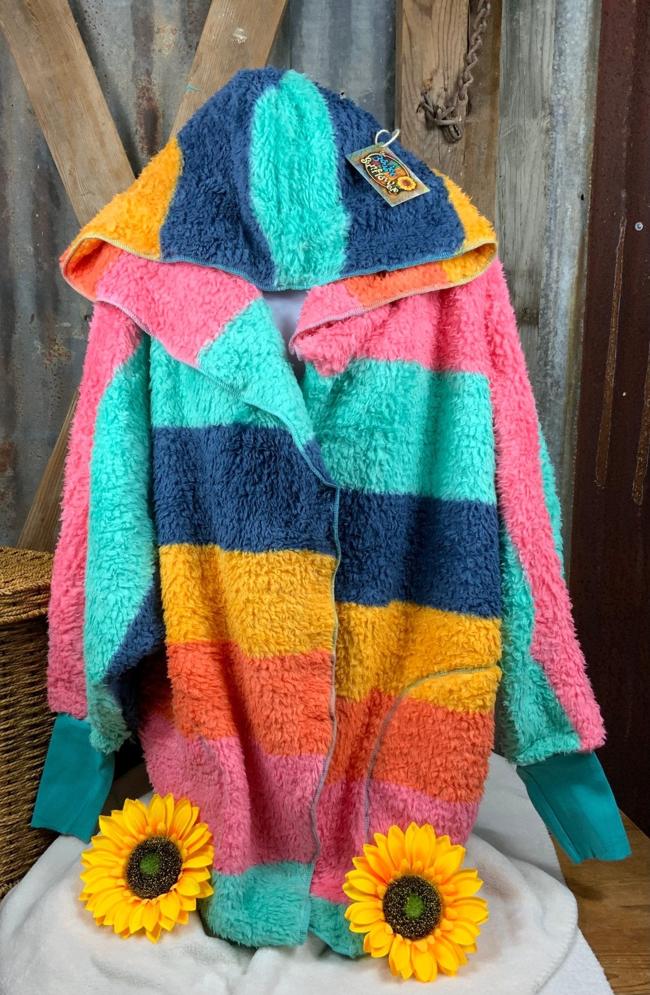 Katydid brand. Lightweight rainbow hoodie wrap with pockets in aqua, navy, pink, gold and orange. One size. $30