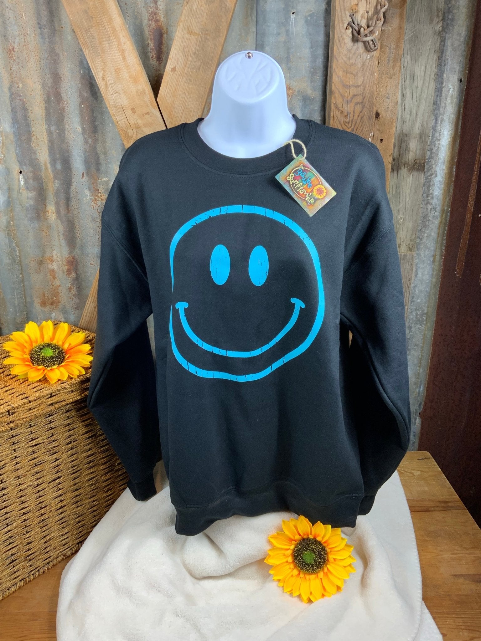 Makayla Grace brand. Black sweatshirt with turquoise outlined happy face. S, L $28