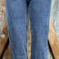 Vintage-inspired high waisted jeans with asymmetrical button closure. Straight legs are slightly tapered at the ankles.