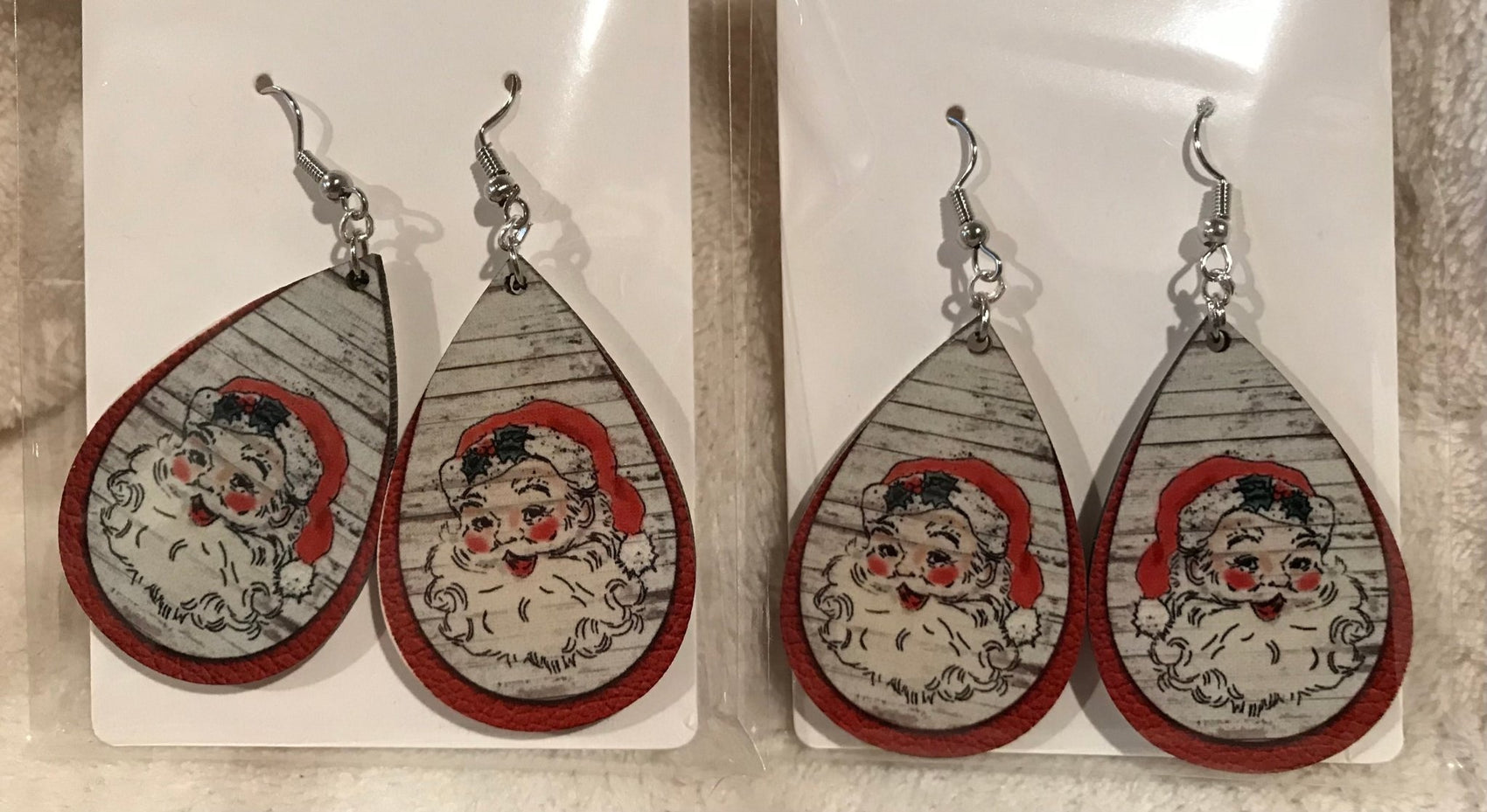 Earring Babe Boutique brand. Silver dangle Santa earrings made in 2.5" hard material with red accent. $7.25