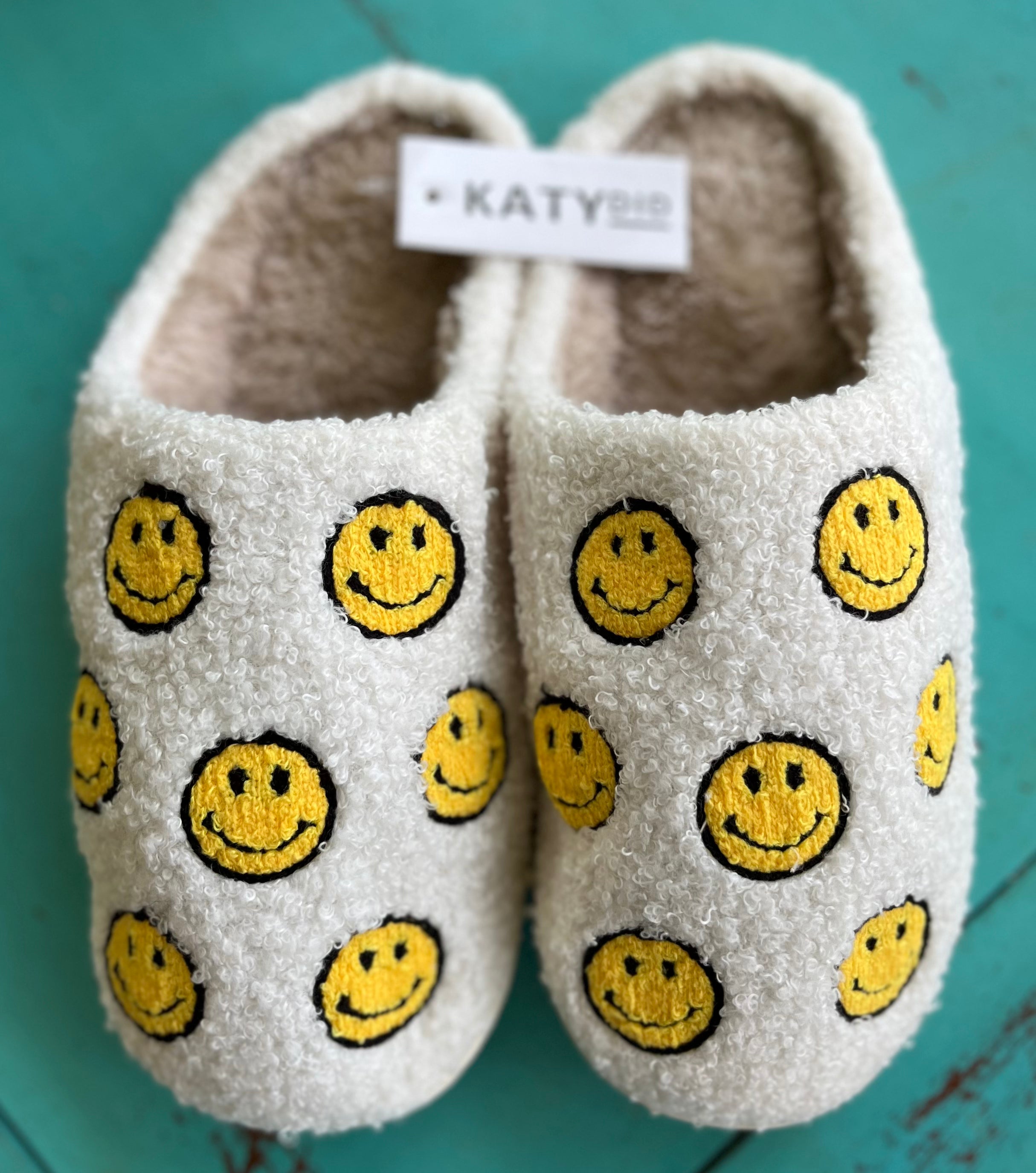 Katydid brand. Soft white exterior with yellow happy faces with beige soft interior and white hard rubber soles for indoor/outdoor wear. S/M fits sizes 6-7, M/L fits sizes 8-9, L/XL fits size 10. $22 