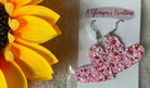 A Glamper's Creation, LLC brand. Silver dangle heart earrings with hot pink, light pink, gold and white glitter. $10