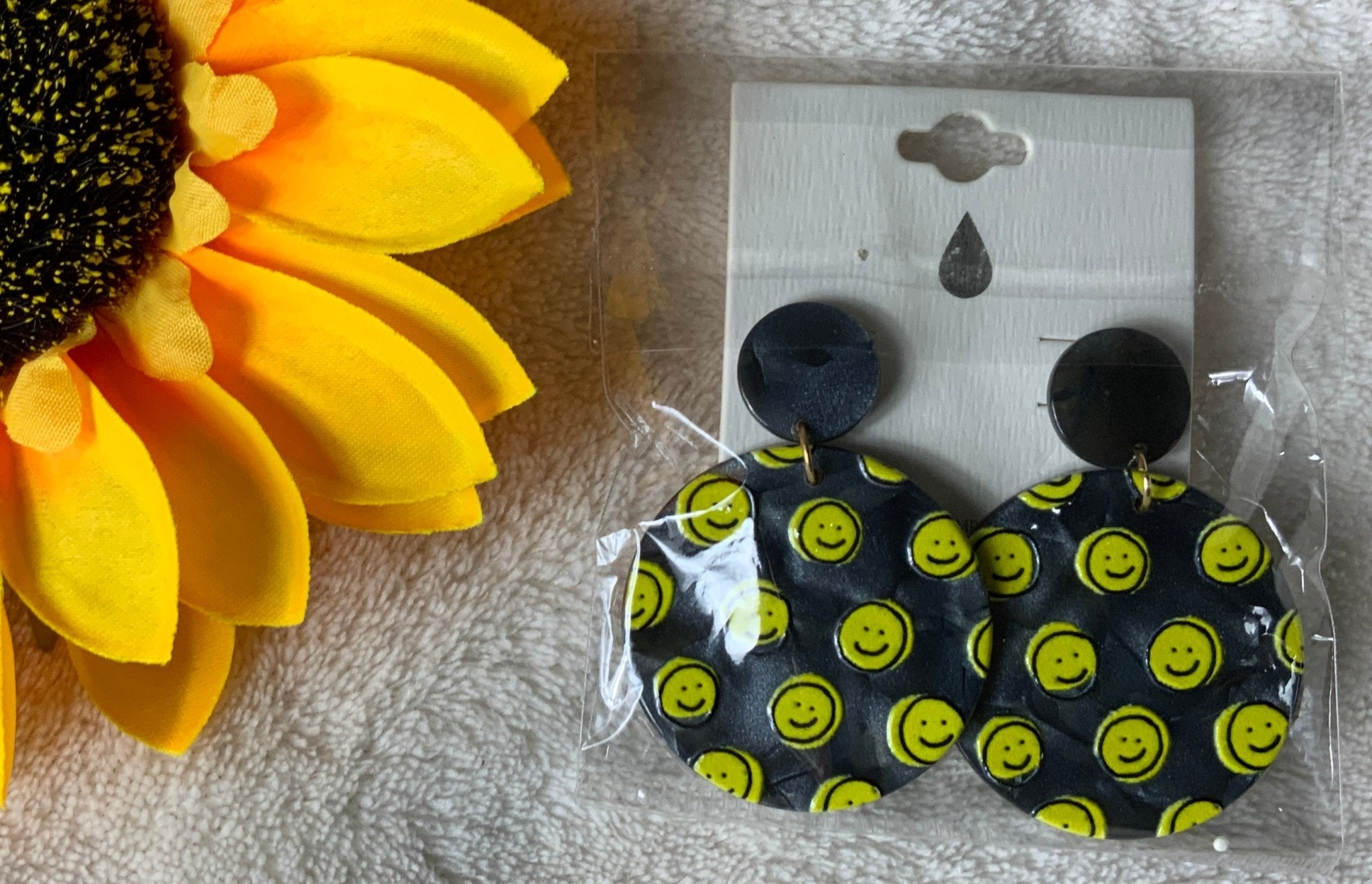 Avenue Zoe brand. Available in black or white hard resin with yellow happy faces and post back earrings. $10