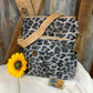 LivFoxy brand. Gray leopard backpack with strap and zippered outer pockets. Tan accented color. Gold hardware. $25