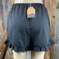 Main Strip brand. Drawstring tie waisted shorts with ruffled bottom hem. Loose fit. Available in Dusty Rose and Black.