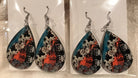 Earring Babe Boutique brand. Made from 2.5" hard material featuring a cow print design with blue and orange detailing. $7.25