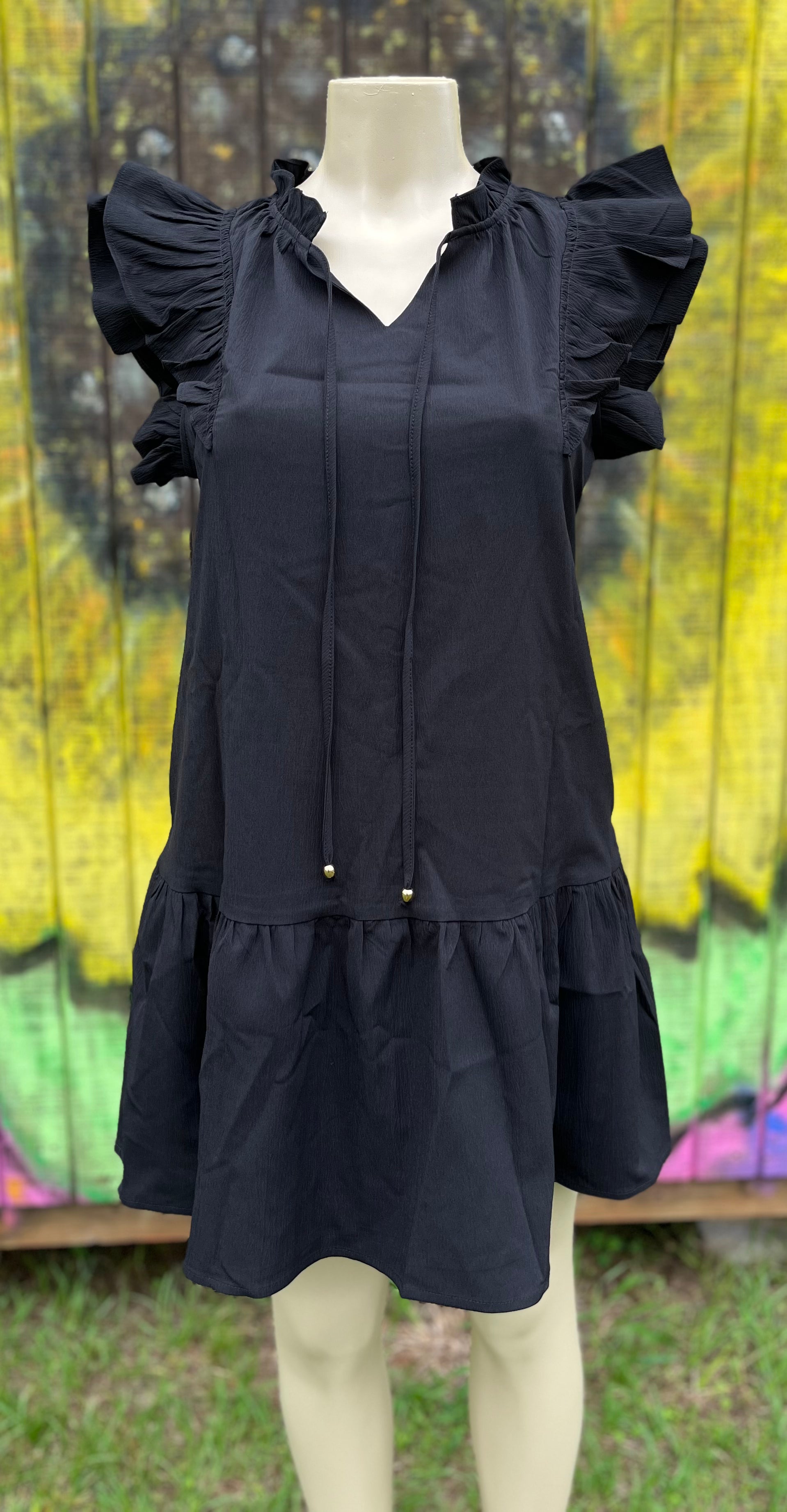 Shiying Fashion brand. Black mini dress with tiered ruffle sleeves, bottom ruffle and side pockets. V-neck ties. 100% polyester. Hand wash. S, M, XL. $27