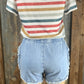 ESLEY brand. High-waisted, light wash denim. Available in blush or blue. Top clasp w/ elastic waist, pockets & shredded hem.