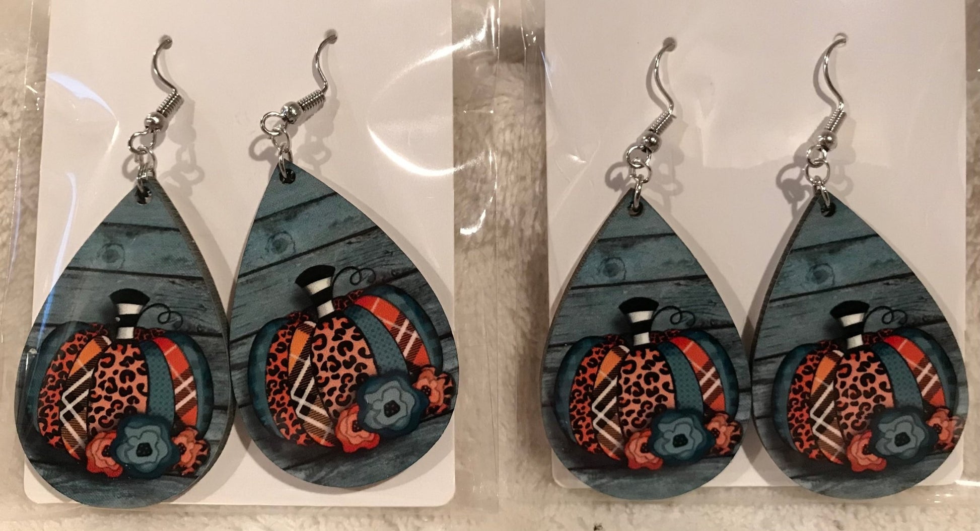 Earring Babe Boutique. 2.5" silver dangle pumpkin earrings in vibrant colors and prints made with hard material. $7.25