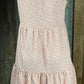 ESLEY. This blush colored white floral, lightweight unlined woven fabric is sleeveless w/ tiered design & ruffled collar.