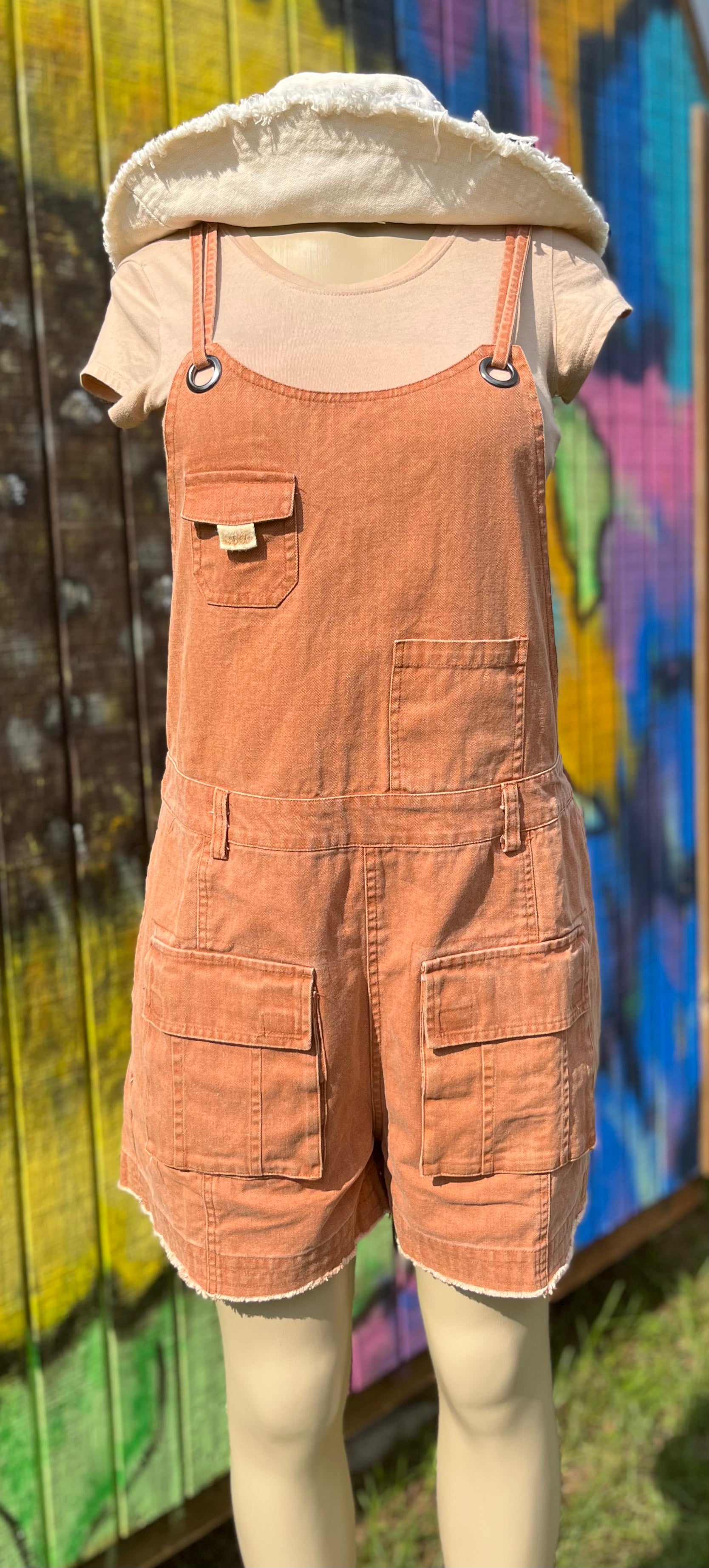 Oli&Hali brand. This camel washed denim romper has 4 front pockets and 2 back pockets. Thin shoulder straps held by brass grommets with back zipper accent and threaded red happy face. TTS. 100% cotton. Handwash cold. Lay flat to dry. S, M, L $50