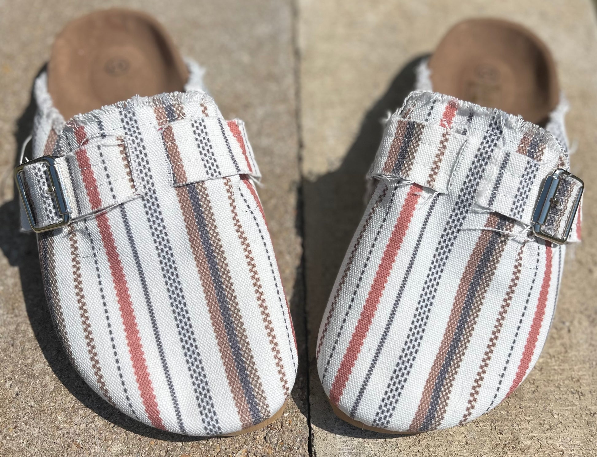 Unishe brand. Casual flat half slip-on shoes with classic striped print and buckle strap design. In sizes: 36/5-5.5, 37/6-6.5, 38/7-7.5, 39/8-8.5, 40/9-9.5, 41/10-10.5, 42/11-11.5. $35